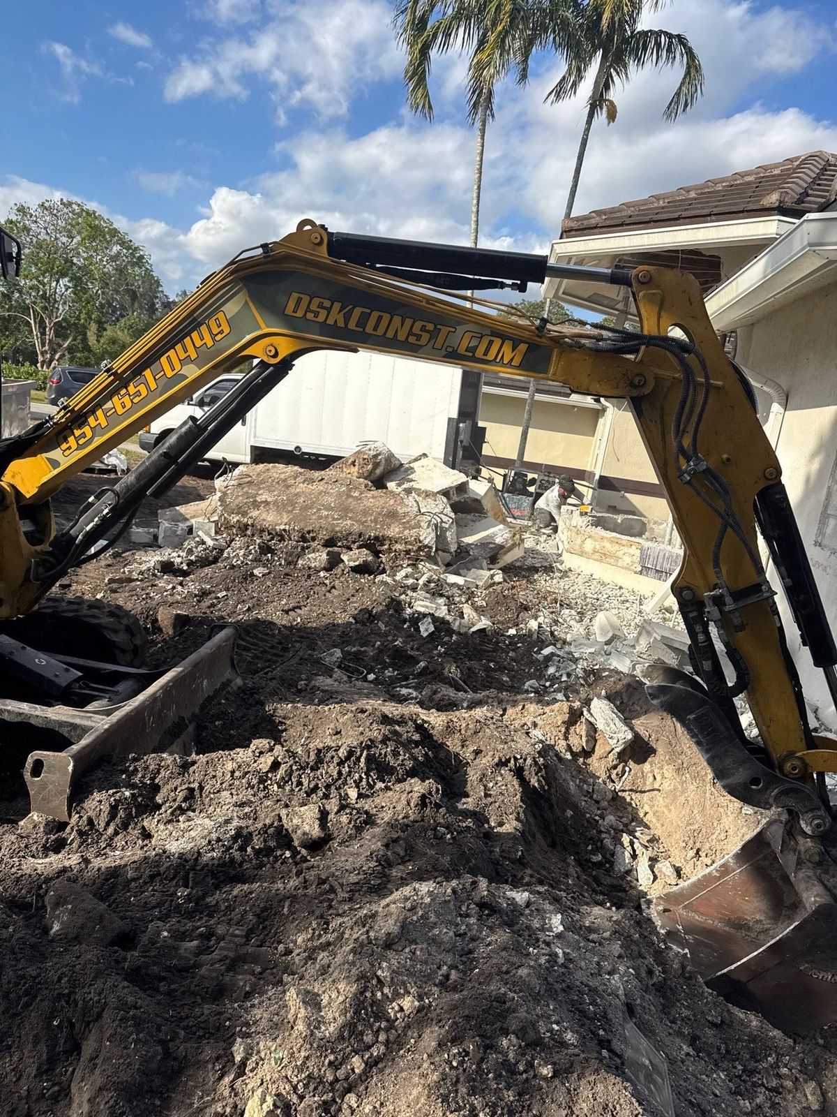 Excavator digging on a residential site preparation job