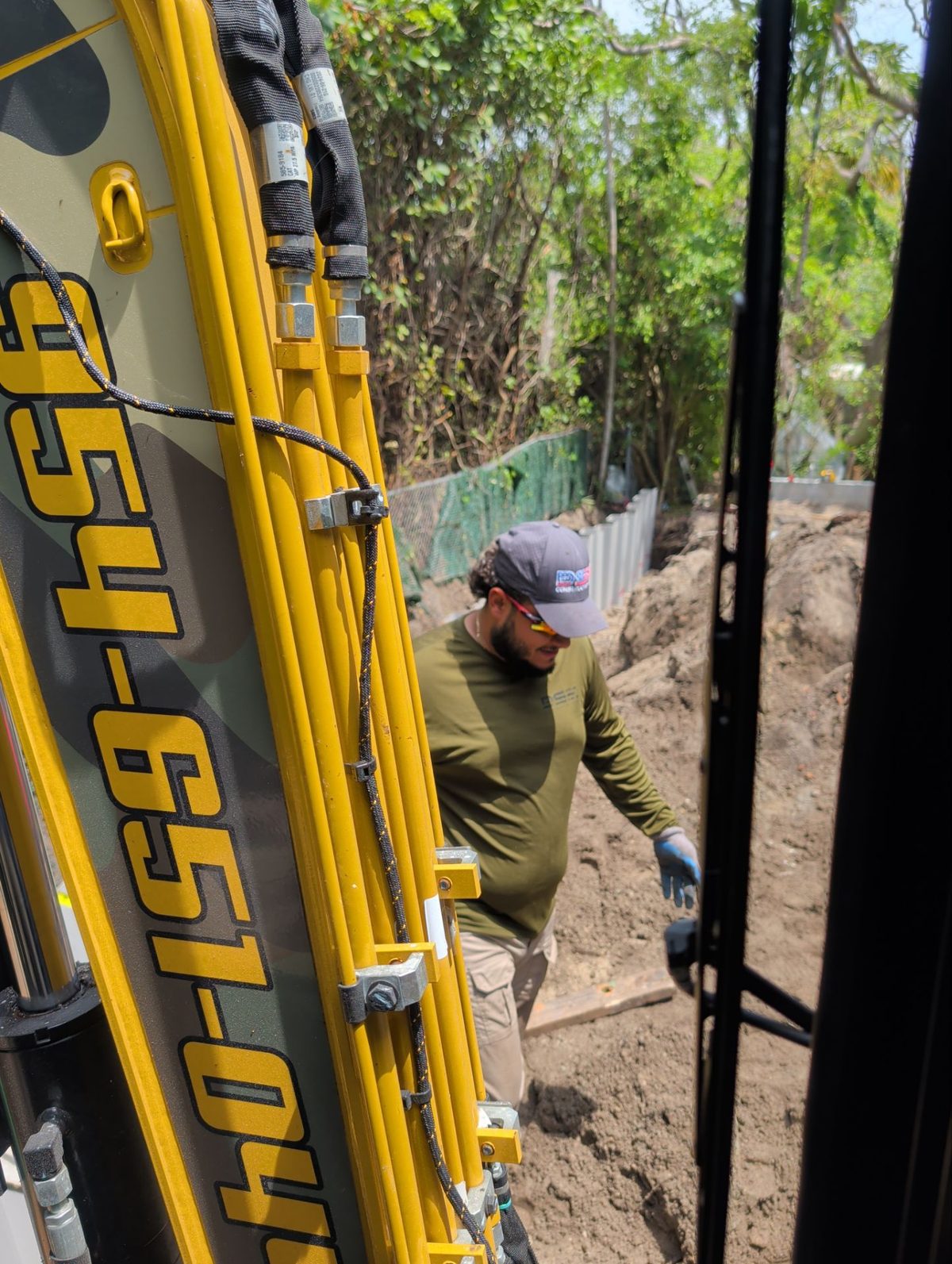 Operator working alongside a DSK-branded excavator