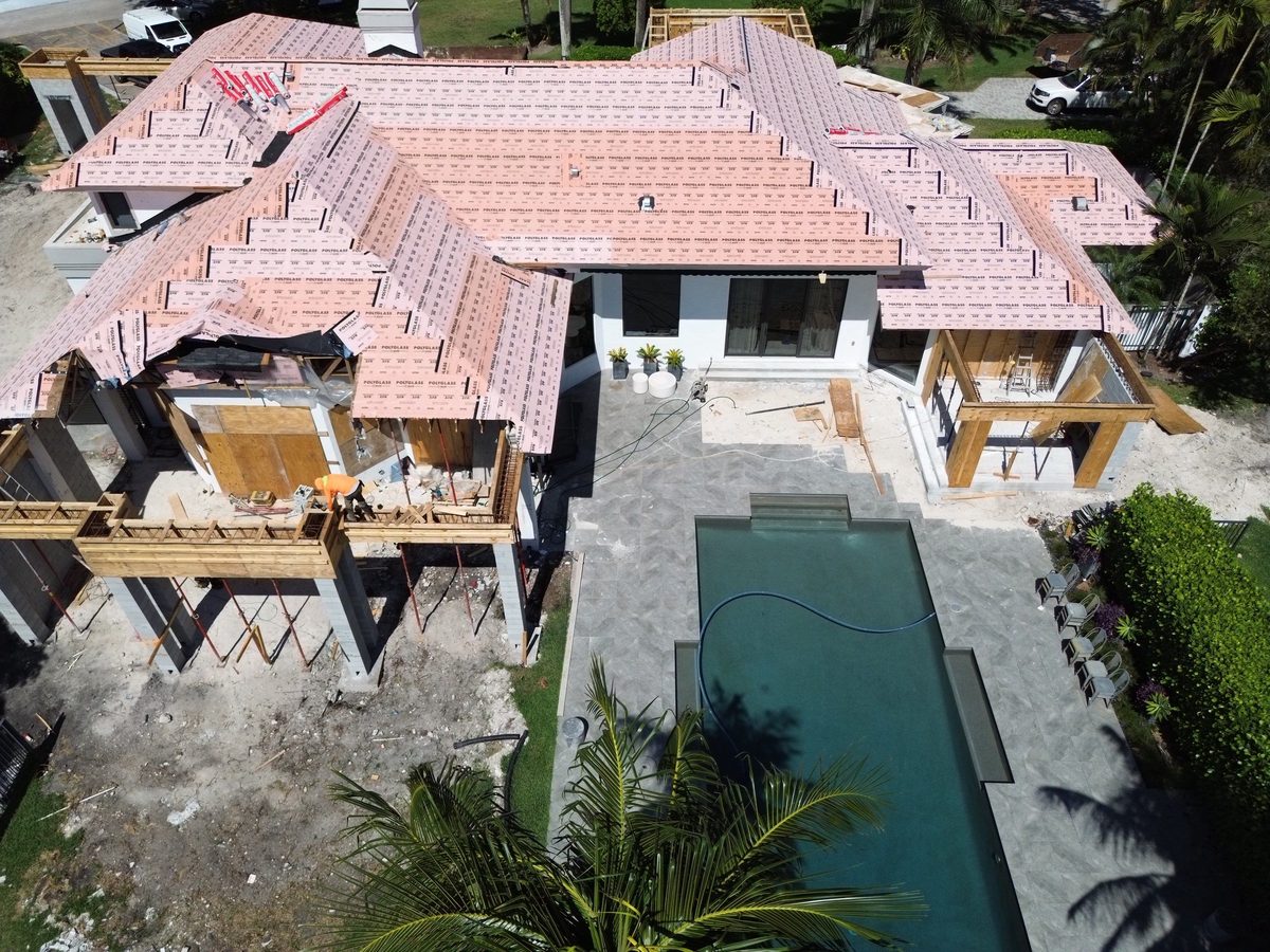 Aerial view of a large residential shell with pool deck