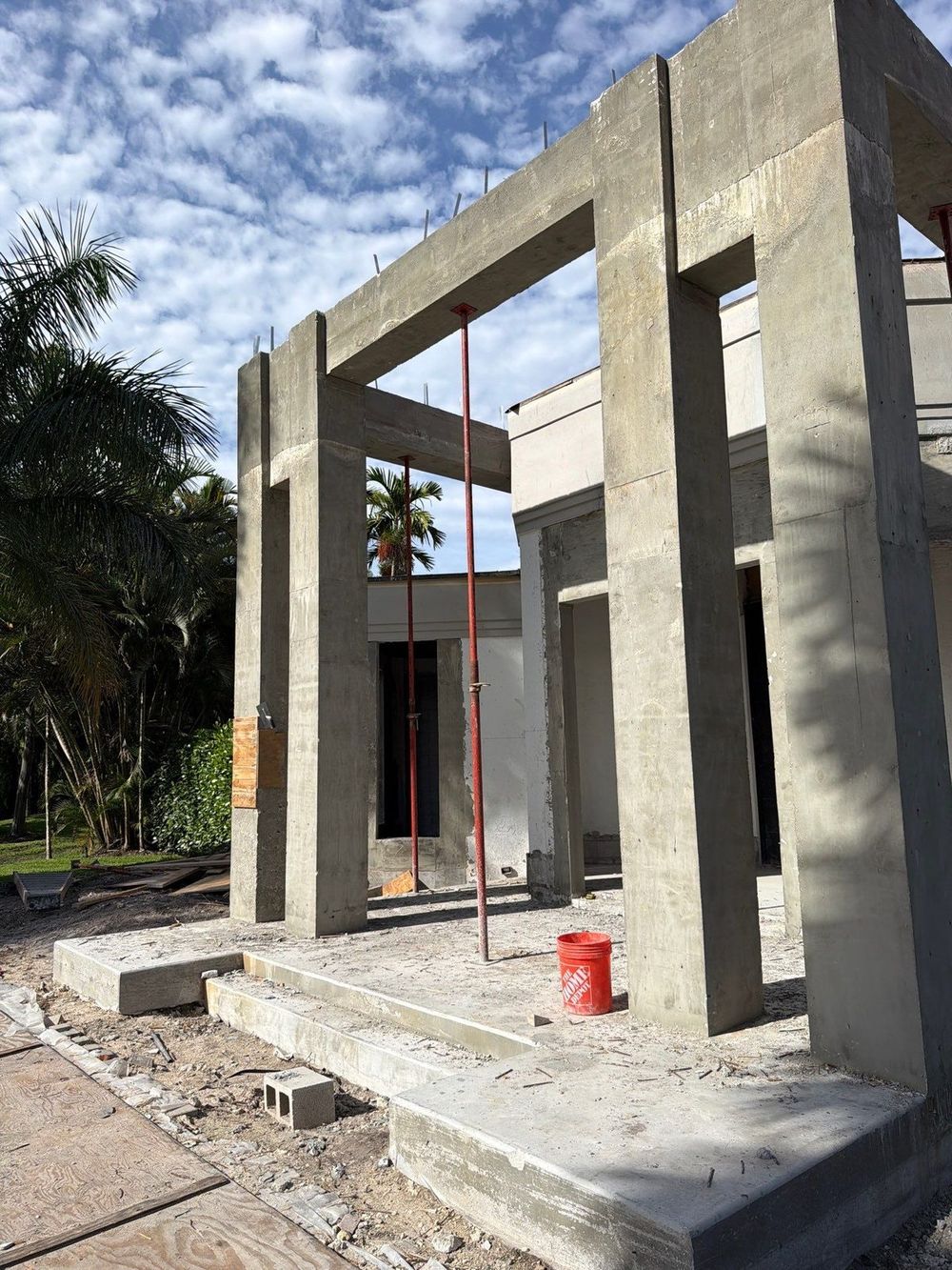Concrete block walls with window openings against blue sky